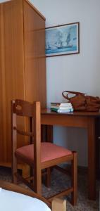 a wooden desk with a chair and a purse on it at FAROS in Agios Nikolaos