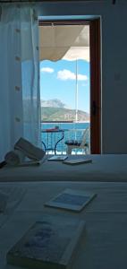 a room with a bed with a view of the ocean at FAROS in Agios Nikolaos