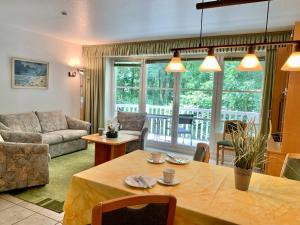 a living room with a table and a couch at Ferienwohnung "Am Waldrand" in Sankt Peter-Ording