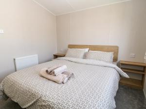 a bedroom with a bed with two towels on it at C22 Par Sands in Par
