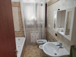 a bathroom with a sink and a toilet and a shower at Casa Vacanze Magnolia in Scanzano
