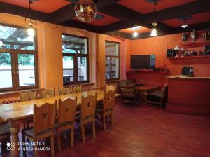 a dining room with a long table and chairs at Agroturystyka Ziemowit Karkonosze in Lubawka