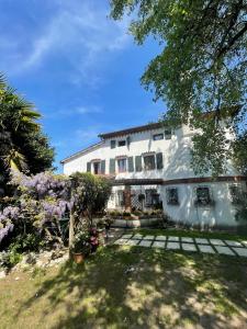 a large white house with a garden in front of it at La Bricola in Cavallino-Treporti +62 photos