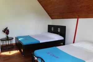 Ένα ή περισσότερα κρεβάτια σε δωμάτιο στο Finca Hotel Pueblito Quindiano