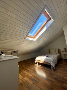 a bedroom with a bed and a window in a attic at Apartments Adaleta in Dubrovnik