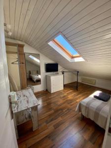 a attic room with a bed and a skylight at Apartments Adaleta in Dubrovnik