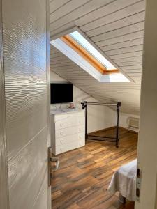 a attic room with a skylight and a desk at Apartments Adaleta in Dubrovnik