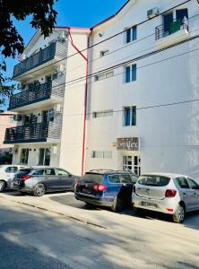 a group of cars parked in front of a building at Casa Alex in Eforie Nord