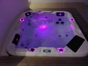 a hot tub with purple lights in a room at Hotel Monte Lírio in Espinho