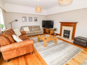 a living room with a couch and a table at Bryn Meilw in Holyhead