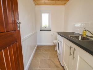a small bathroom with a sink and a toilet at Bryn Meilw in Holyhead +32 photos