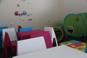 a childs room with colorful chairs and a table at Hotel Monte Lírio in Espinho
