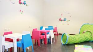 a dining room with colorful tables and chairs at Hotel Monte Lírio in Espinho