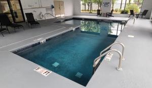a swimming pool in a building with blue water at Red Roof Inn Florence, SC in Florence