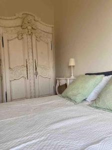 a bedroom with a large bed with two pillows at Peaceful retreat in Drome Provencale Castel in Montboucher-sur-Jabron