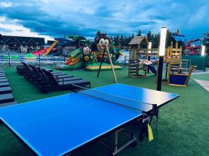 a ping pong table in a playground at dream-apartments in Bešeňová