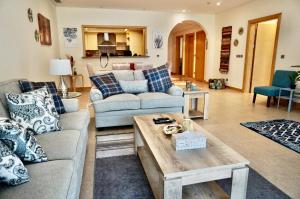 a living room with a couch and a table at Luxury Apartment Palm Jumeirah in Dubai