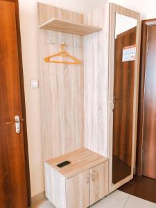 a shower with a wooden cabinet in a room at Kontinent Hotel in Mukacheve