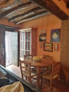 a dining room with a wooden table and chairs at Casa Arroyo in Benalauría