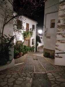 a cobblestone street in a town at night at Casa Arroyo in Benalauría
