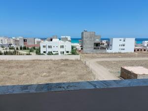 a view of a city with buildings and the ocean at Super corner in Ḩammām al Ghazzāz