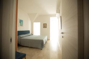 - une chambre avec un lit et une porte menant à une pièce dans l'établissement Appartamenti sul mare Alassio, à Alassio
