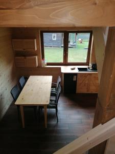 a table and chairs in a tiny house at Chatka pod Krzemienna in Cisna