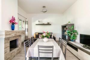 a dining room with a table and chairs and a fireplace at Montorfano By The Lake - My Home In Como in Montorfano