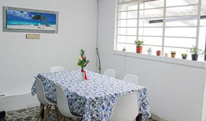 a dining room table with a blue and white table cloth at El Cable Hostal in Manizales