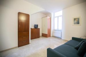 - un salon avec un canapé bleu et une commode dans l'établissement Appartamenti sul mare Alassio, à Alassio