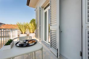 a tray of food on a table on a balcony at Villa Fedora Luxury Suites in Lucca