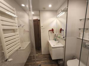 a bathroom with a toilet sink and a shower at Archie's Apartment in Old Town in Batumi
