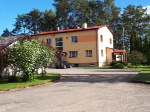 a large house with a driveway in front of it at Jõesuu Home Accommodation in Purtsi
