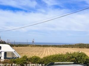 a white van parked in front of a field at Gwens Garden bell tent in St. Just