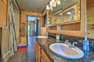 a bathroom with two sinks and a large mirror at Direct Hiking Access Riverfront Dolores Home! in Dolores +30 photos