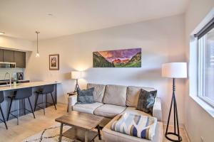 a living room with a couch and a kitchen at Cozy Bozeman Condo with Proximity to Downtown! in Bozeman