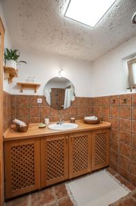 a bathroom with a sink and a mirror at Boutique House Vresje in Bohinjska Bistrica