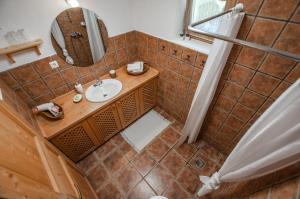 an overhead view of a bathroom with a sink and mirror at Boutique House Vresje in Bohinjska Bistrica +38 photos
