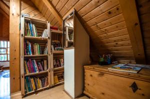 a room with bookshelves and a door into a library at Boutique House Vresje in Bohinjska Bistrica