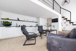 a living room with a couch and a table at DO DOMIS LOFT PALANGA in Palanga
