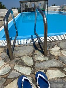 a pair of shoes next to a swimming pool at Siskosplace in Oia
