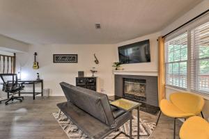 a living room with a couch and a fireplace at Modern Nashville Townhome Large Yard and Deck! in Nashville