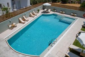 an overhead view of a large swimming pool with lounge chairs at Incognito Creta Luxury Suites and More in Kolymvari