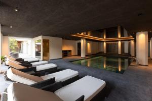 a living room with a pool and some couches at Am Brunnen Apartments in Natz-Schabs