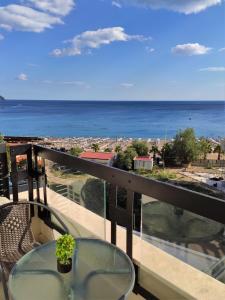 a balcony with a table and a view of the ocean at Silver Beachfront Becici in Becici