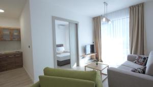 a living room with a couch and a mirror at Silver Beachfront Becici in Bečići