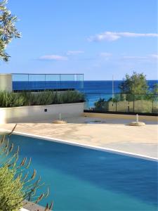 a swimming pool with a view of the ocean at Silver Beachfront Becici in Becici