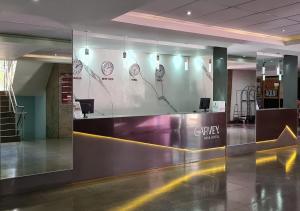 a lobby with a reception desk in a building at IKA Apart Hotel in Brasília