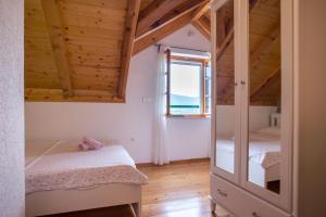 a bedroom with two bunk beds and a window at Holiday Village Home Kamenica in Kostanje