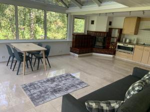 a kitchen and living room with a table and chairs at Chalet Finkenwiese in Zweisimmen